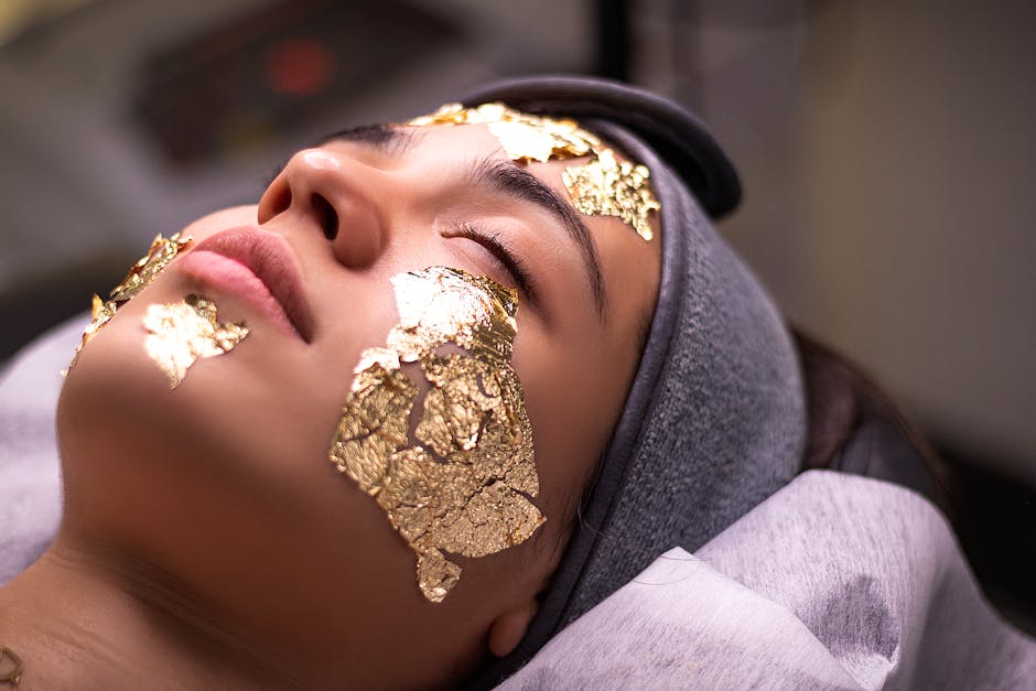 Professional esthetician performing gold facial massage technique in Nashik spa