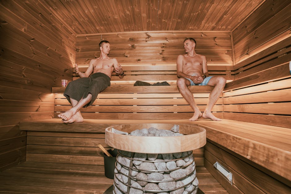 Person relaxing in wooden sauna bath with towel in Nashik wellness center