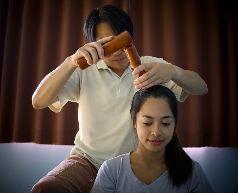 Thai massage practitioner performing acupressure techniques on client