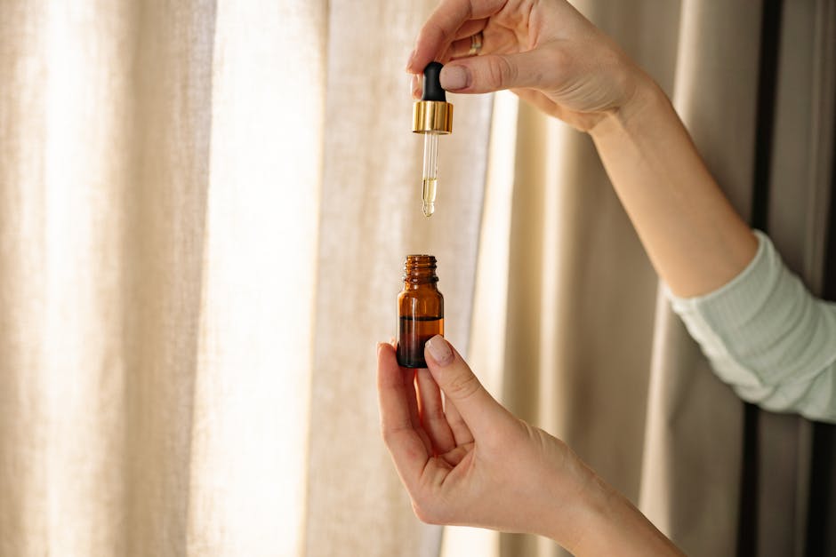 Spa therapist preparing Vitamin C serum and treatment products for facial application